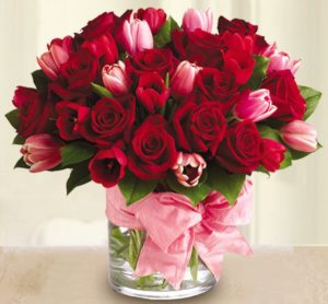 Fragrant red roses and delicate tulips accented with a pink bow are two of our most beautiful blooms and the best way to tell someone “I love you”.