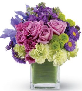 lavener and pink roses with lilies and green floral accents in cube vase