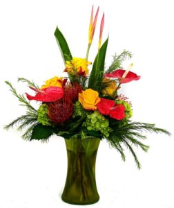 brown pincushion protea with red and yellow flowers and greens in vase