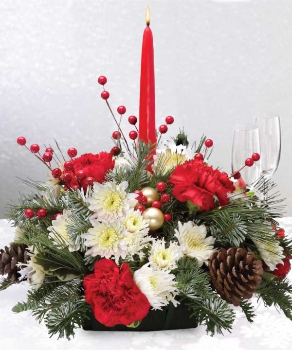 Loaded with holiday cheer, our centerpieces feature a splendid assortment of holiday flowers, candles, ornaments and lush Christmas greens. Approx: 10"w x 6"h (not including candle)