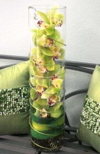 Zen is the art of reflection and meditation, and this striking flower arrangement of one tall green cymbidium orchid stem