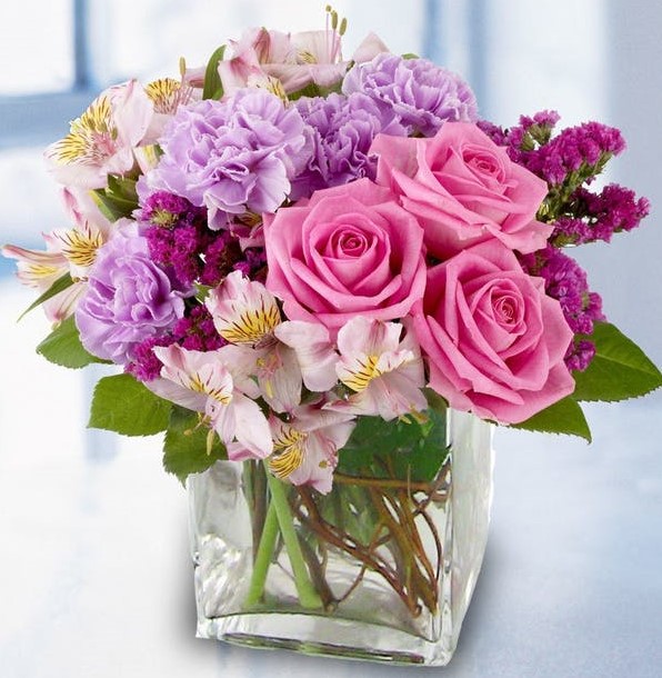 A glamorous bouquet of fresh flowers in delectable shades of raspberry, lavender and pink roses, alstroemeria lilies and more is sure to delight any lucky recipient.