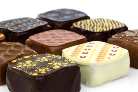 assorted decorated luxury chocolate bonbons on a white background