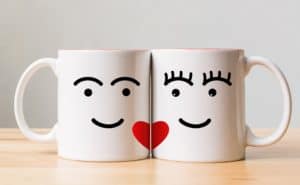 2 white mugs with red hearts