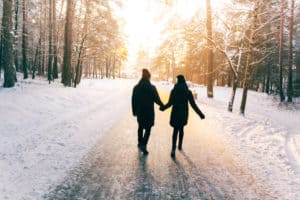 Couple walking in the snow and holding hands